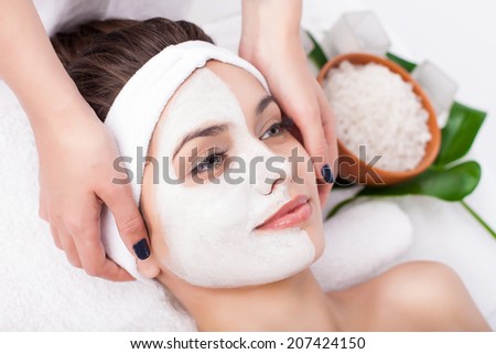 Facial mask of caucasian young female. Spa treatment