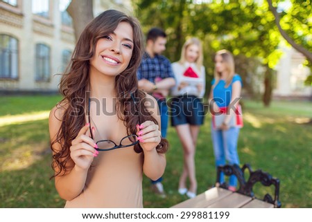 Shot of college students hanging out on campus. Happy classmates