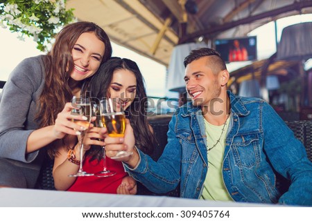 Friends at party drinking cocktails and having fun - Three tourists drinking aperitif in a restaurant