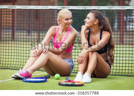 Beautiful female tennis players playing doubles at tennis at the tennis court