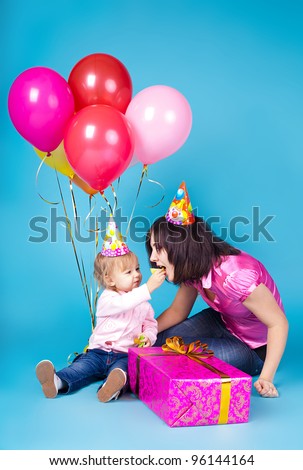 The family, mother and child celebrate with a gift and balloons