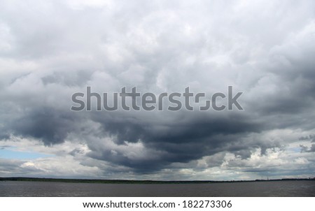 Dark clouds over the river