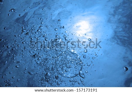 Air bubbles rising to water surface with sunlight in background, natural scene, Caribbean sea
