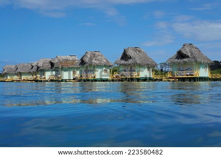 Over water bungalows with thatch roof in the Caribbean sea, Central America, Panama