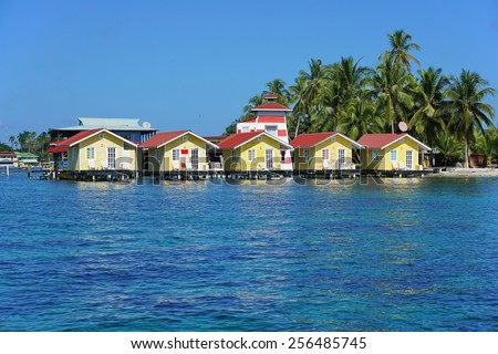 Tropical cabins over water of the Caribbean sea, Carenero island, Bocas del toro, Panama