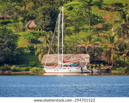 Tropical coast with a sailboat a dock, Caribbean sea, Panama