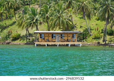 Coastal property with coconut trees and a tropical house over water, Caribbean sea, Panama, Central America