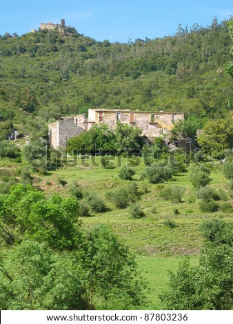 A farm in ruin and the remains of Mont-Roig castle perched on a peak, Mediterranean country, Darnius, Catalonia, Spain
