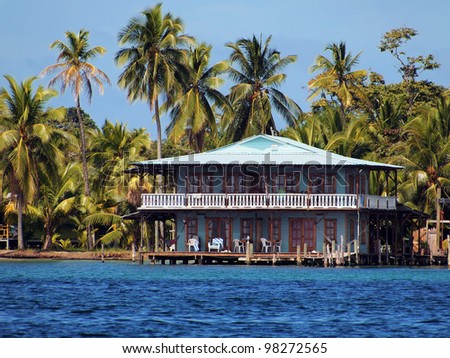 Beautiful typical Caribbean hotel over the sea with coconut trees, Bocas del Toro, Panama