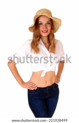 A beautiful blond woman in a white blouse and blue jeans, wearing a  straw hat, standing isolated for white background.
