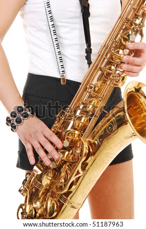 A young Asian woman standing in the studio, playing the saxophone in shorts with suspender, in closeup, for white background.