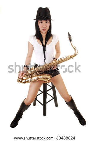 A beautiful Chinese woman with her saxophone on her lap, sitting on a chair in the studio for white background.