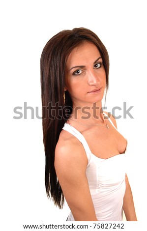 A beautiful young woman in a white top standing in the studio and her long hair falls on her back, for white background.