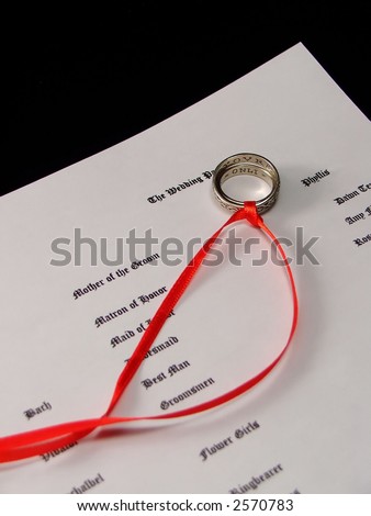 wedding rings with trailing ribbons on program