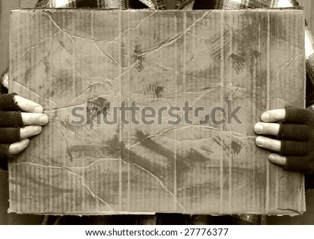 man holding blank worn out cardboard sign