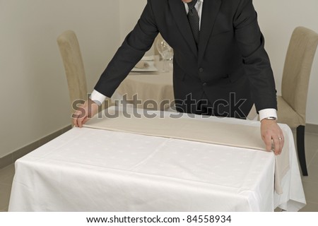 Putting the tablecloth on a square table