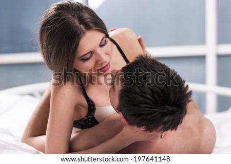 Young passionate couple making love in bed