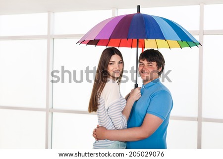 Happy smiling couple under a umbrella