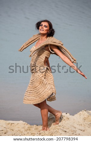 Woman enjoying freedom feeling happy at beach. Beautiful serene relaxing woman in pure happiness and elated enjoyment with arms raised outstretched up.