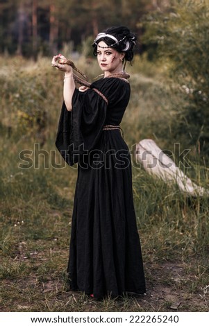 Evil witch woman casting a spooky spell with magic hands. Witchcraft