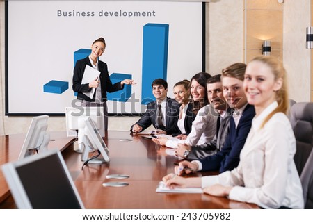 Business consultant answering a question during a meeting at office
