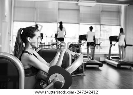 Gym fitness club indoor with young women training weights with hands