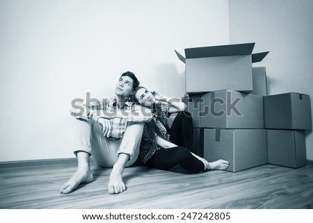 Young couple with boxes dream of a happy life