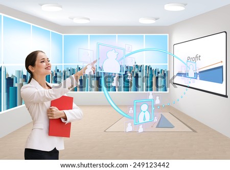 Interface business office of the future, a woman in office with skyscrapers on background pushing on virtual buttons