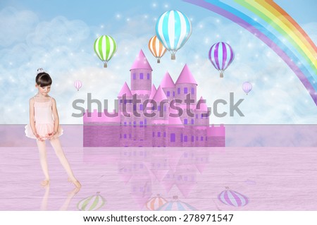 Little girl in a balerina costume in front of a pink fairy castle