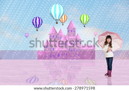 Little girl with an umbrella in front of a pink fairy castle