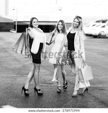 Group of girls after shopping on a parking