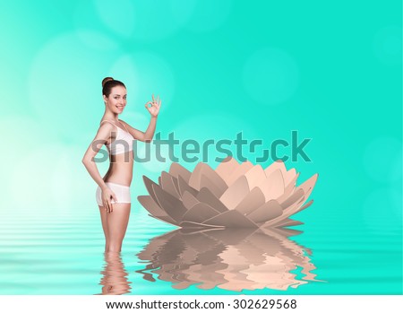 Sexy fit woman with healthy clean skin on the background of lotus