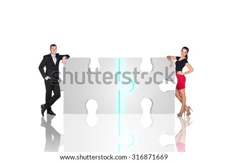 Two business people are standing near puzzle parts in order to succeed on the white background.