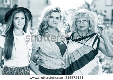 Grandmother ,mother and daughter  in the summer park