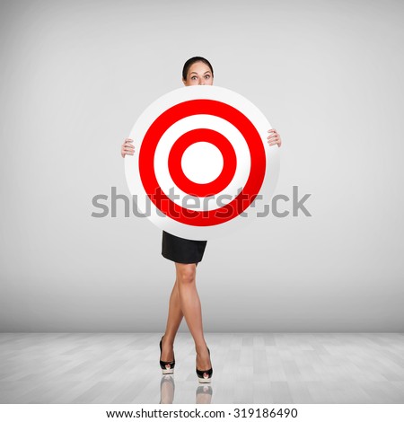 Business woman holding big target. Success concept portrait.