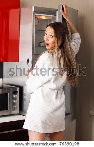 Sexy, hungry woman near fridge