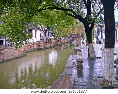 JINXI, SHANGHAI, CHINA  FEBRUARY 6: raining on a typical village water way. The ancient village is a Shanghai tourist attraction with 100000 visitors per year. February 6, 2005, Jinxi, China