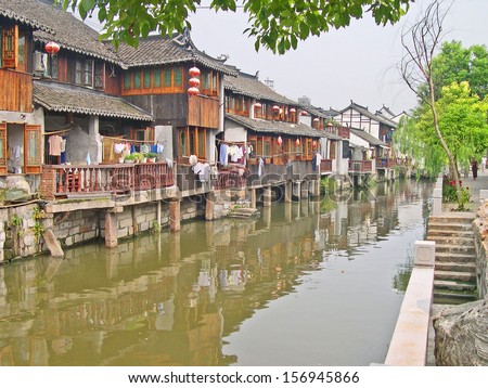 FENGJING, SHANGHAI, CHINA  SEPTEMBER 19: life along a village canal. The ancient village is a Shanghai tourist attraction with 100000 visitors per year. September 19, 2004, Fengjing, China