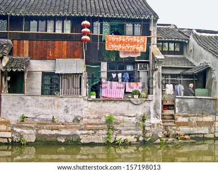 FENGJING, SHANGHAI, CHINA - SEPTEMBER 19: old houses along the main canal. The ancient village is a Shanghai tourist attraction with 100000 visitors per year. September 19, 2004, Fengjing, China