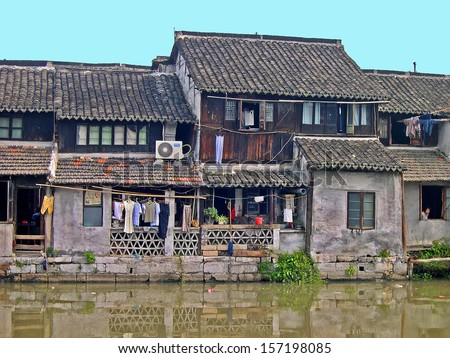 FENGJING, SHANGHAI, CHINA - SEPTEMBER 19: old houses along the main canal. The ancient village is a Shanghai tourist attraction with 100000 visitors per year. September 19, 2004, Fengjing, China.