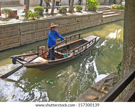 LUZHI, SHANGHAI, CHINA Ã¢Â?Â? OCTOBER 30: lady running a taxi boat. The ancient village is a Shanghai tourist attraction with 100000 visitors per year. October 30, 2004 Luzhi, China.