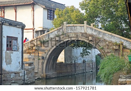 JINXI, SHANGHAI, CHINA  JANUARY 9: old bridge over the village waterway. The ancient village is a Shanghai tourist attraction with 100000 visitors per year. January 9, 2010, Jinxi, China