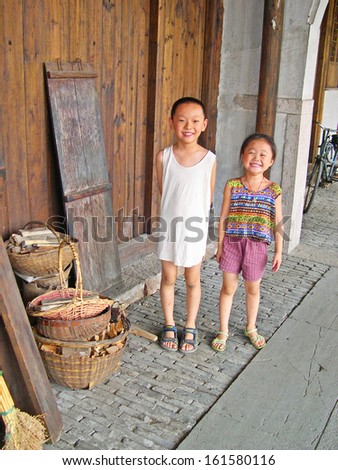 NANXUN, SHANGHAI, CHINA Ã¢Â?Â? AUGUST 28: young girls smiling. The water Nanxun village is Shanghai tourist attraction with 100000 visitors year. August 28, 2004,Nanxun, China