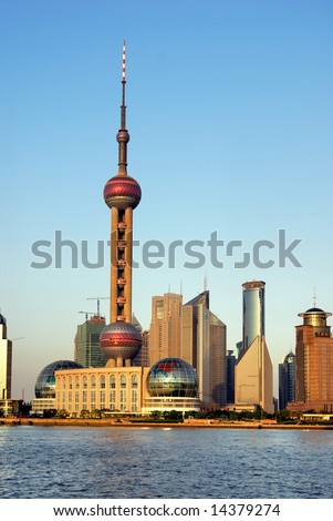 China Shanghai Pudong riverfront buildings at sunset and the pearl tower