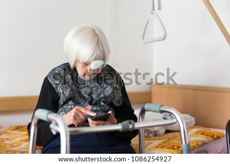 Similar – Image, Stock Photo Lonley elderly 95 years old woman sitting at the bad using modern mobile phone.