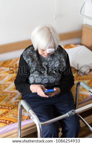 Similar – Image, Stock Photo Lonley elderly 95 years old woman sitting at the bad using modern mobile phone.