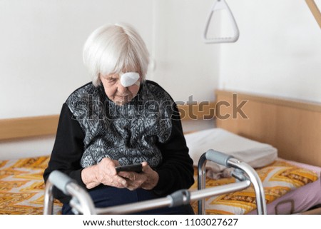 Similar – Image, Stock Photo Lonley elderly 95 years old woman sitting at the bad using modern mobile phone.