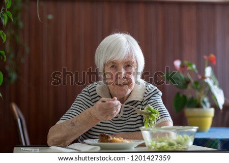 Similar – Foto Bild Einsame ältere Frau, die ihr Mittagessen im Altersheim verzehrt.