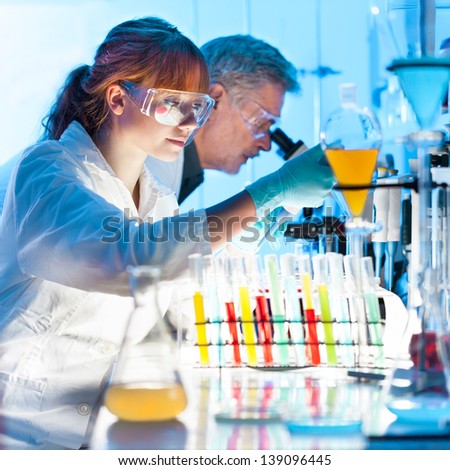 Similar – Image, Stock Photo Young scientist pipetting solution.