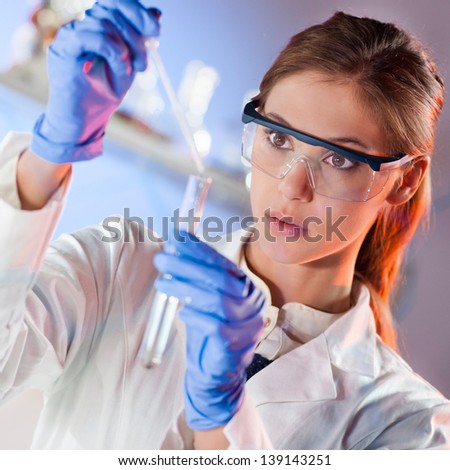 Similar – Image, Stock Photo Young scientist pipetting solution.